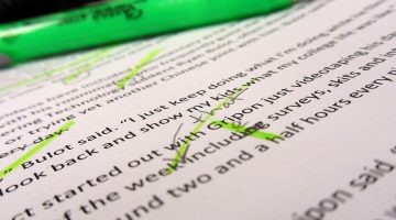 Green highlighter and paper with edited text