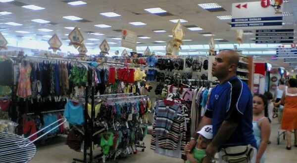 Man and children shopping in clothes store.