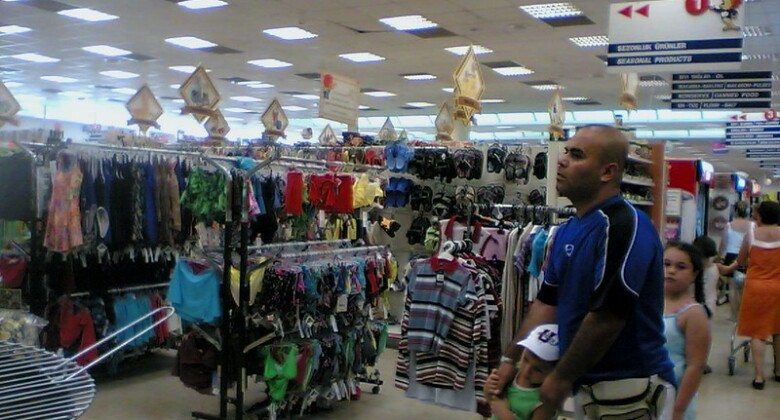 Man and children shopping in clothes store.