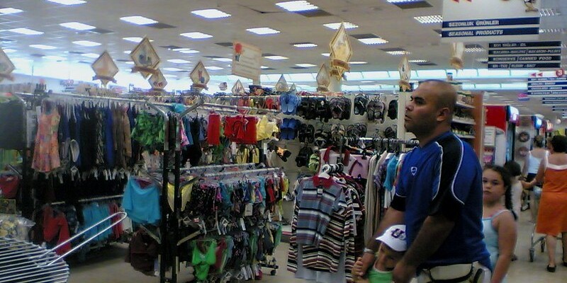 Man and children shopping in clothes store.